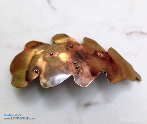 Brass Barrette Oak Leaf Hair Clip, Mixed metal look rustic barrette. Handcrafted from pure brass, torch fired, metal balls soldered on the brass with copper tones coming through the metal. Nice one of a kind torched rustic metal hair clip, no other one quite like this one is going to walk by! This leaf barrette was handcut from brass sheet, shaped and formed and then torch fired. The top side is sealed with jewelry clear coat. Glued with a high grade glue that stays a bit flexible to take the repeated use. Pure brass, one of a kind handmade creations for your special hair accessory collection! About 5 x 2 inches. Standard 3 inch barrette spring clasp. The barrette clip is a  3 inch size clip (medium). It will generally accommodate all of thinner or fine hair and with thicker hair you can wear it office chic with part of the hair pulled back with it or over a ponytail holder where you attach it to just part of the hair.  Please email me with any questions. Handmade in the USA.