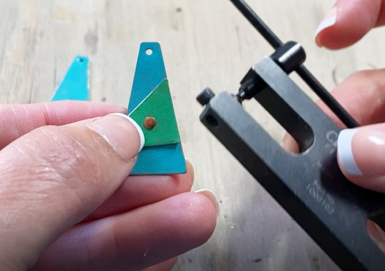 inserting rivet through metal pieces
